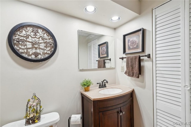 bathroom with toilet and vanity