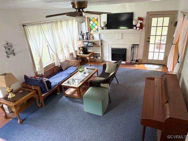 111 Jefferson St, Emporia, VA 23847 - living area with a ceiling fan, a brick fireplace, and wood finished floors