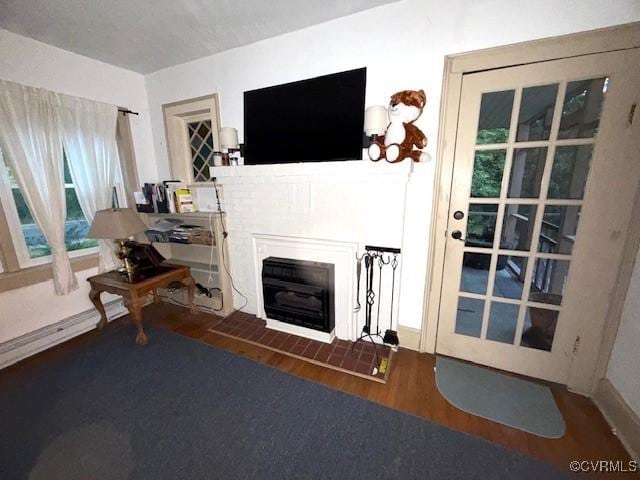111 Jefferson St, Emporia, VA 23847 - living area with wood finished floors and a fireplace with flush hearth
