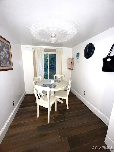 111 Jefferson St, Emporia, VA 23847 - dining room with baseboards and dark wood-style flooring