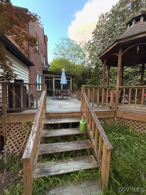 111 Jefferson St, Emporia, VA 23847 - wooden deck with a gazebo, stairs, and outdoor dining space