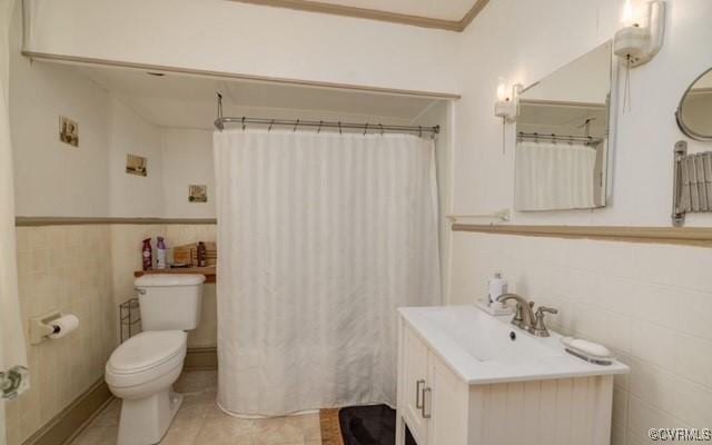 111 Jefferson St, Emporia, VA 23847 - full bathroom with toilet, tile walls, a shower with shower curtain, vanity, and wainscoting