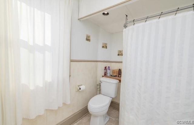 111 Jefferson St, Emporia, VA 23847 - full bath with toilet, curtained shower, and tile patterned flooring