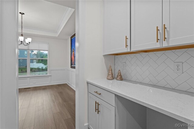 9975 Honeybee Dr, Mechanicsville, VA 23116 - kitchen with a tray ceiling, dark wood-style flooring, light stone counters, white cabinets, and tasteful backsplash