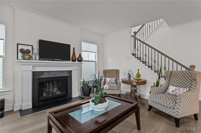 9975 Honeybee Dr, Mechanicsville, VA 23116 - living room with wood finished floors, ornamental molding, a glass covered fireplace, stairway, and baseboards