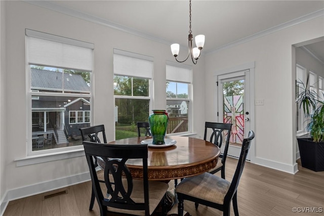 9975 Honeybee Dr, Mechanicsville, VA 23116 - dining area with wood finished floors, ornamental molding, baseboards, and a chandelier