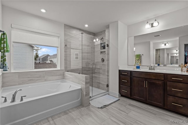 9975 Honeybee Dr, Mechanicsville, VA 23116 - bathroom with a garden tub, vanity, a shower stall, and recessed lighting