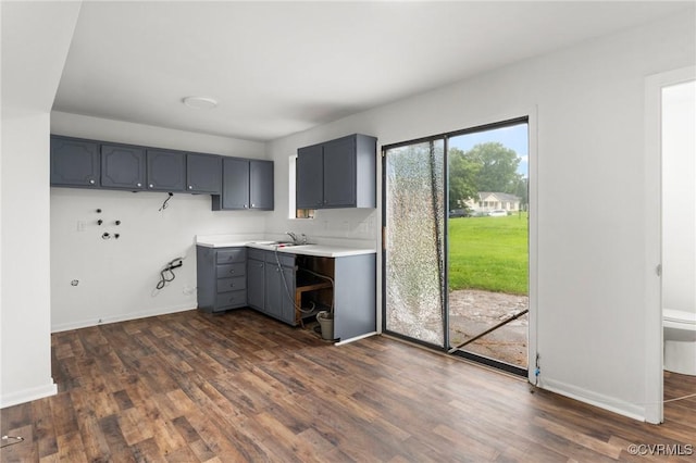 306 Cedarwood Rd, Henrico, VA 23075 - kitchen featuring gray cabinetry, a sink, dark wood-type flooring, and light countertops