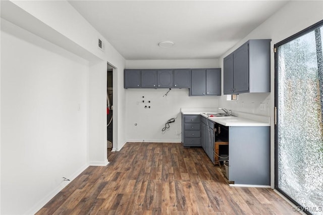 306 Cedarwood Rd, Henrico, VA 23075 - kitchen with gray cabinetry, dark wood-style flooring, light countertops, a sink, and baseboards