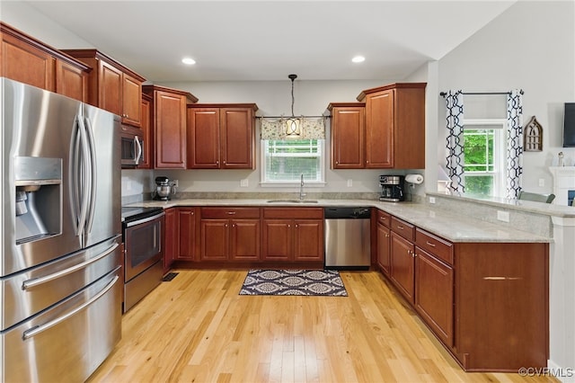 10335 Deerlake Dr, New Kent, VA 23124 - kitchen with appliances with stainless steel finishes, a sink, a peninsula, light wood-style flooring, and plenty of natural light
