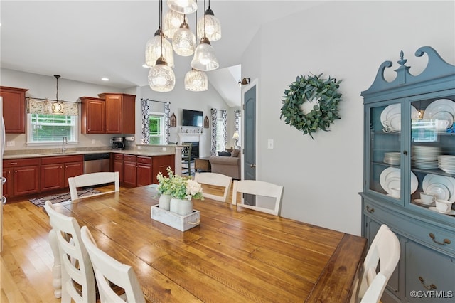 10335 Deerlake Dr, New Kent, VA 23124 - dining area with a fireplace, lofted ceiling, and light wood finished floors