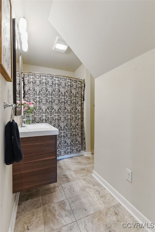 10335 Deerlake Dr, New Kent, VA 23124 - full bathroom with vanity and baseboards