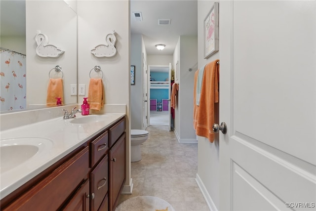 10335 Deerlake Dr, New Kent, VA 23124 - full bath featuring double vanity, toilet, and baseboards