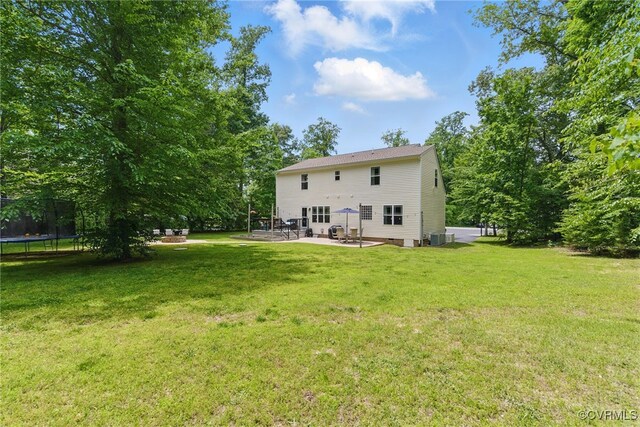10335 Deerlake Dr, New Kent, VA 23124 - rear view of property featuring a trampoline, a patio, a yard, and cooling unit