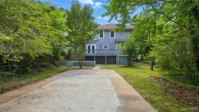 back of property with a lawn