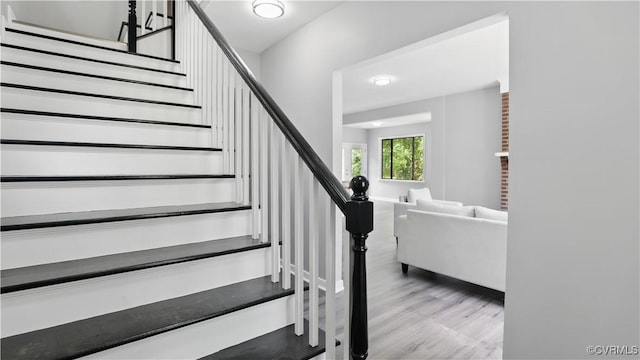 stairway featuring wood finished floors