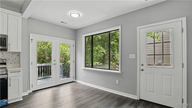 doorway to outside with french doors, plenty of natural light, dark wood-type flooring, and baseboards