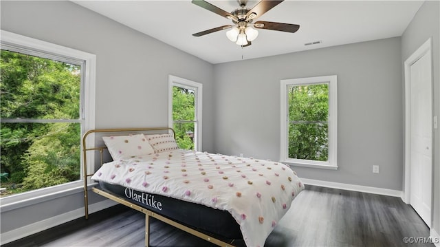 bedroom with baseboards, wood finished floors, and ceiling fan