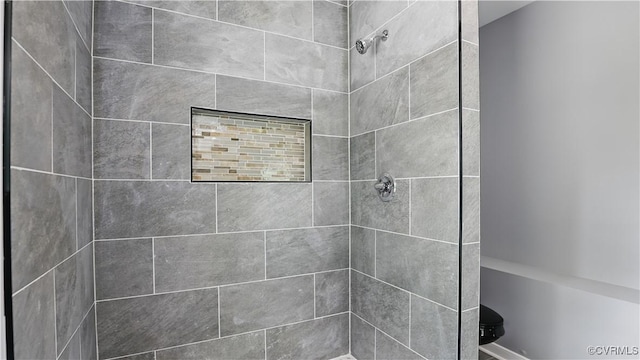 bathroom with a tile shower