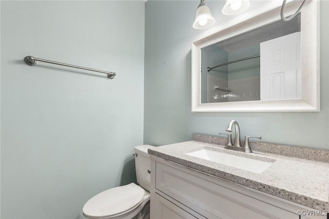 bathroom featuring toilet and vanity