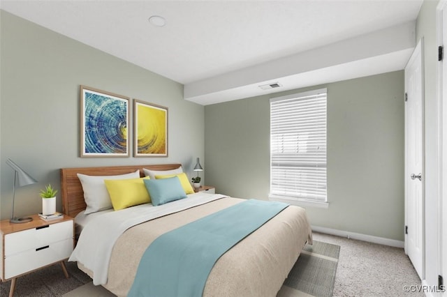 carpeted bedroom featuring baseboards