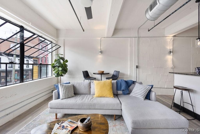 living room featuring wood finished floors and beam ceiling