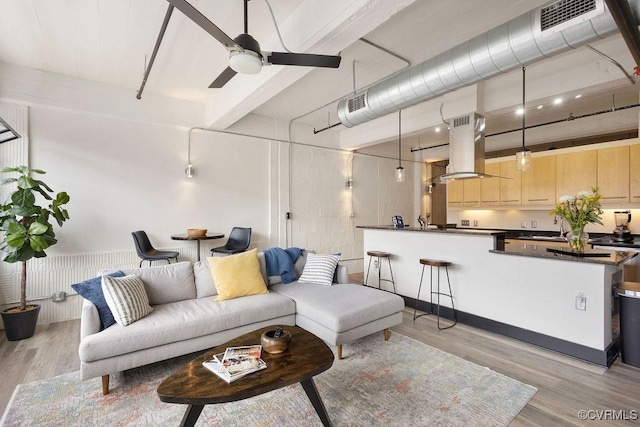 living room featuring light wood-style floors, ceiling fan, and beam ceiling
