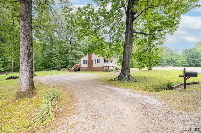 9830 Knobs Hill Ln, Amelia Courthouse, VA 23002 - view of front of home with dirt driveway, a front yard, and a forest view