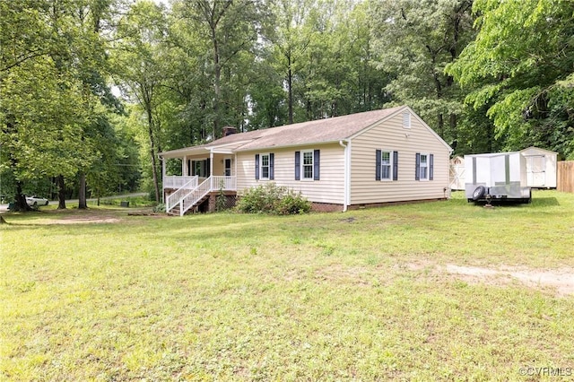 9830 Knobs Hill Ln, Amelia Courthouse, VA 23002 - manufactured / mobile home featuring a porch, a shed, a front yard, an outdoor structure, and a chimney
