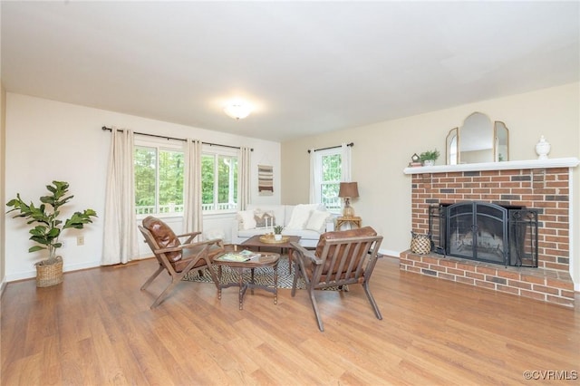 9830 Knobs Hill Ln, Amelia Courthouse, VA 23002 - living room featuring wood finished floors, a brick fireplace, and baseboards