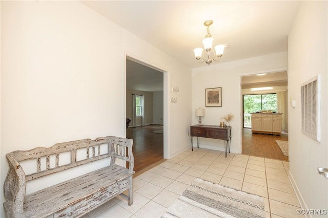 9830 Knobs Hill Ln, Amelia Courthouse, VA 23002 - hallway with a chandelier, light tile patterned flooring, and baseboards