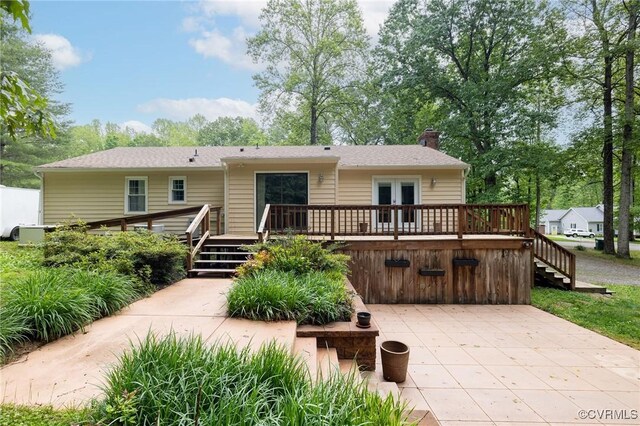 9830 Knobs Hill Ln, Amelia Courthouse, VA 23002 - view of front of house with stairs, a wooden deck, a chimney, french doors, and a patio area