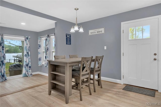 686 Shore Dr, Hartfield, VA 23071 - dining area with baseboards, light wood-type flooring, and healthy amount of natural light