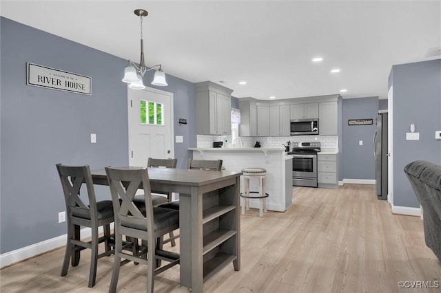 686 Shore Dr, Hartfield, VA 23071 - dining room with light wood-style floors, a chandelier, baseboards, and recessed lighting
