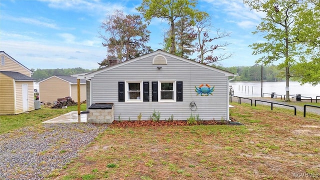 686 Shore Dr, Hartfield, VA 23071 - view of front facade featuring a water view and a patio area