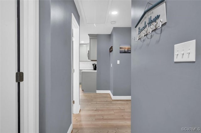 686 Shore Dr, Hartfield, VA 23071 - hall featuring attic access, light wood-style flooring, and baseboards