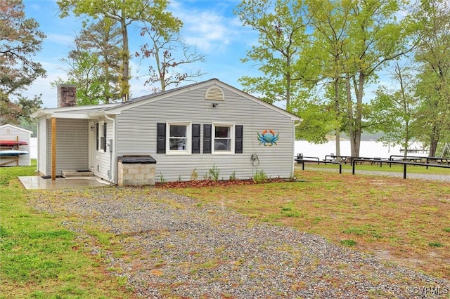 686 Shore Dr, Hartfield, VA 23071 - rear view of property with a chimney