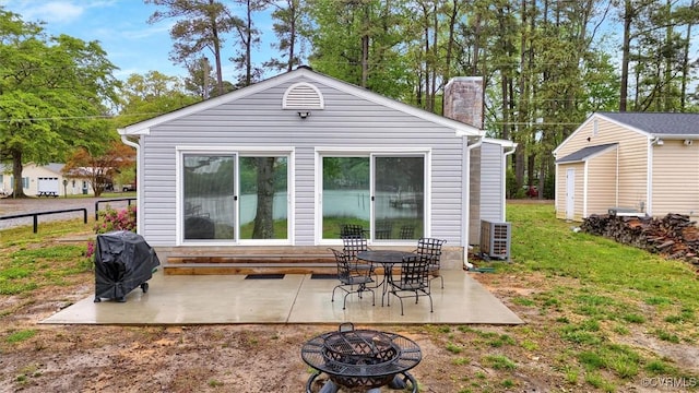 686 Shore Dr, Hartfield, VA 23071 - back of house featuring an outdoor fire pit, a patio area, and a chimney