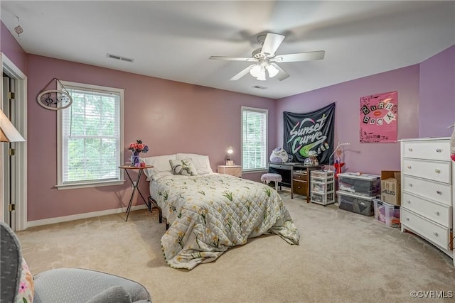 bedroom featuring carpet flooring, multiple windows, ceiling fan, and baseboards