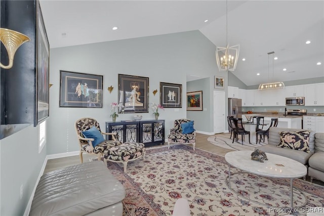 926 Old Saint Johns Rd, Irvington, VA 22480 - living room featuring baseboards, light wood-style floors, high vaulted ceiling, a chandelier, and recessed lighting