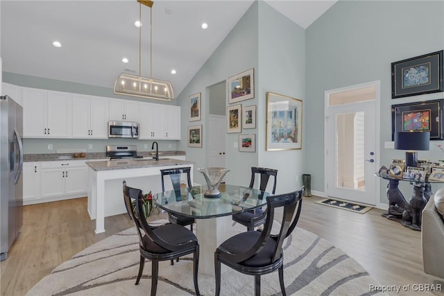926 Old Saint Johns Rd, Irvington, VA 22480 - dining space featuring high vaulted ceiling, light wood-style flooring, recessed lighting, and baseboards