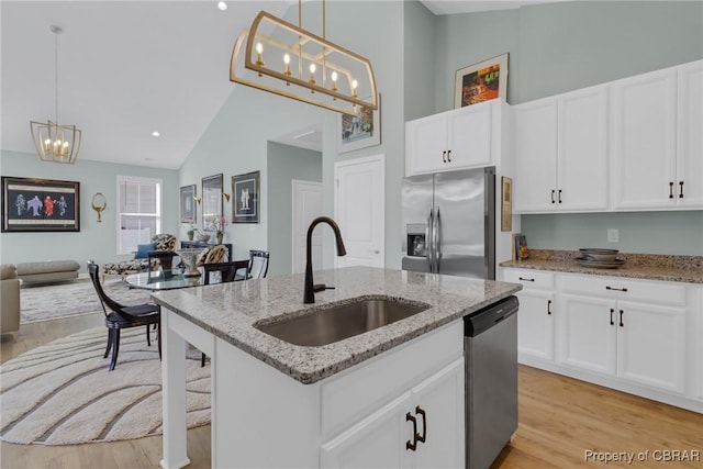 926 Old Saint Johns Rd, Irvington, VA 22480 - kitchen with a sink, stainless steel appliances, high vaulted ceiling, light wood-style floors, and open floor plan