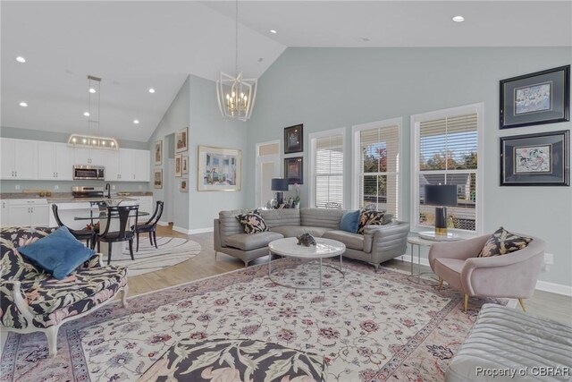 926 Old Saint Johns Rd, Irvington, VA 22480 - living area featuring a chandelier, high vaulted ceiling, light wood-style floors, baseboards, and recessed lighting