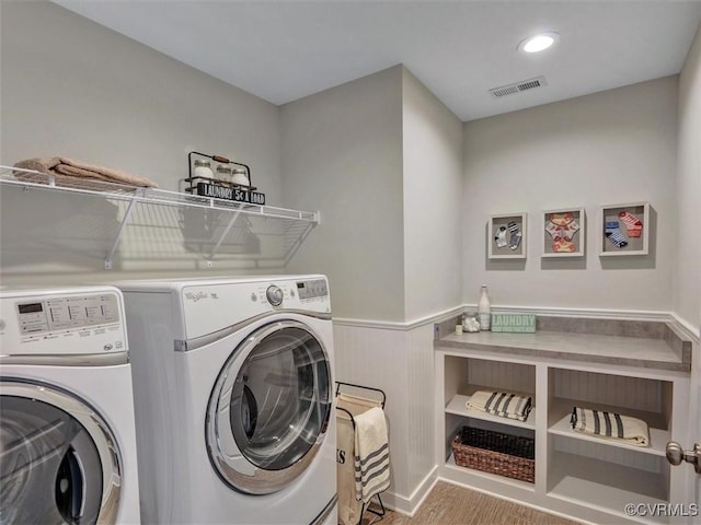 washroom featuring wood finished floors, independent washer and dryer, wainscoting, and recessed lighting