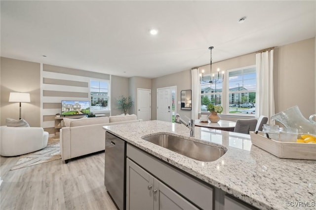 5916 Banyan Ln, Chesterfield, VA 23234 - kitchen featuring a sink, stainless steel dishwasher, light wood-type flooring, hanging light fixtures, and light stone countertops