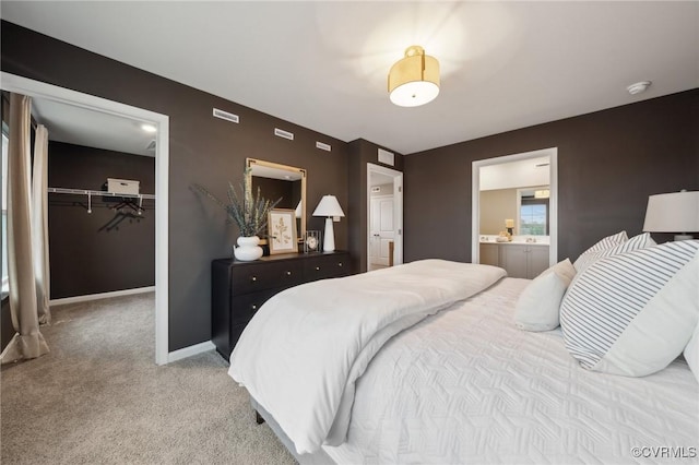 5912 Banyan Ln, Chesterfield, VA 23234 - carpeted bedroom featuring a walk in closet, a closet, ensuite bath, and baseboards