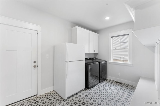 laundry area with independent washer and dryer, light flooring, baseboards, cabinet space, and recessed lighting