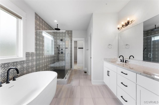 bathroom with healthy amount of natural light, a stall shower, and a freestanding tub