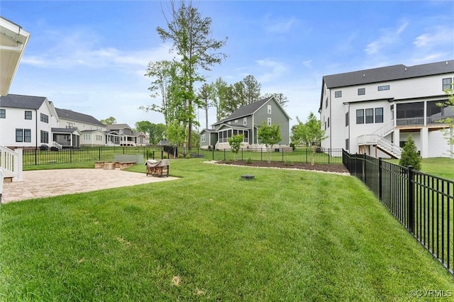 view of yard with a residential view and a patio area