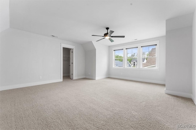 bonus room with light carpet, baseboards, and ceiling fan